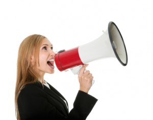 Female executive yelling through a megaphone